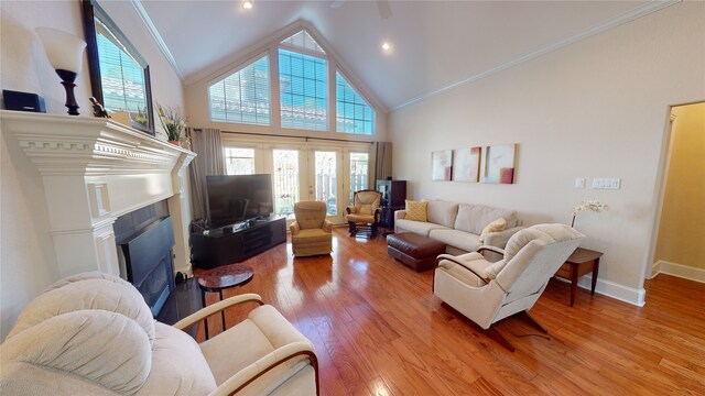 living room featuring crown molding, hardwood / wood-style floors, high vaulted ceiling, and a healthy amount of sunlight