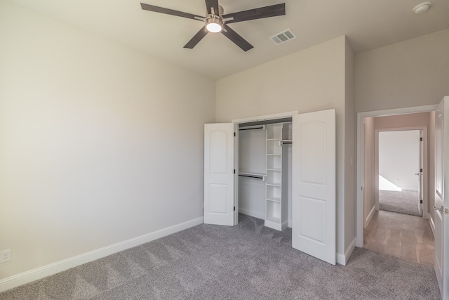 unfurnished bedroom with carpet, ceiling fan, and a closet