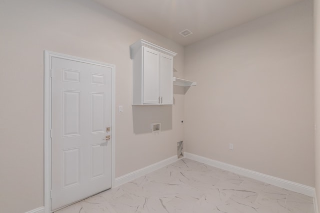 clothes washing area with hookup for an electric dryer, washer hookup, and cabinets