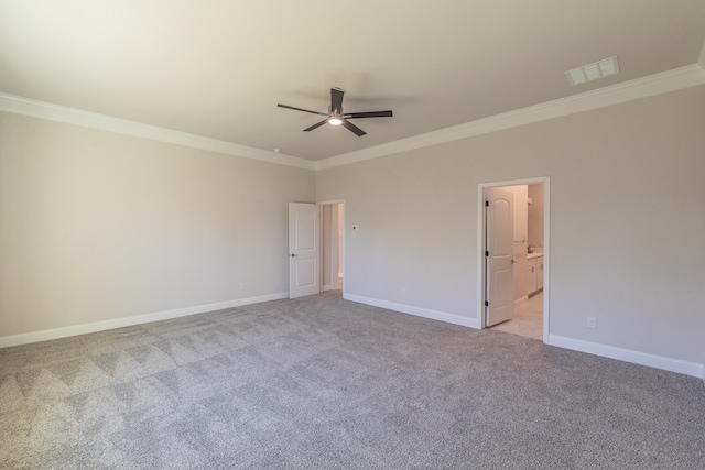 empty room featuring ceiling fan, crown molding, and light carpet