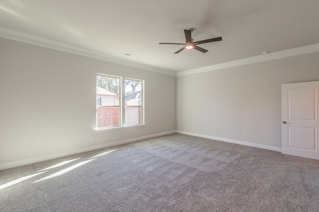 carpeted empty room featuring ceiling fan and crown molding