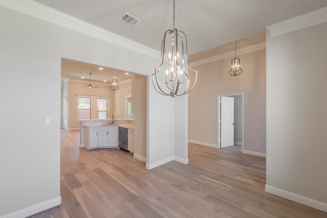 unfurnished dining area with ceiling fan, sink, light wood-type flooring, and crown molding