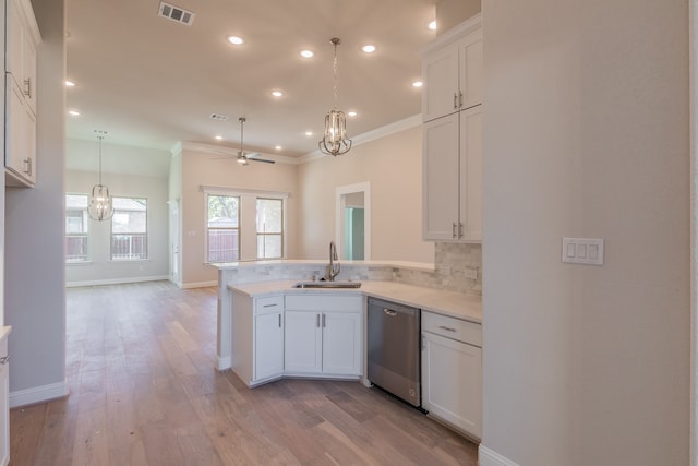 kitchen featuring white cabinetry, dishwasher, ceiling fan, sink, and kitchen peninsula