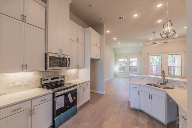 kitchen featuring sink, light hardwood / wood-style flooring, ceiling fan, white cabinetry, and stainless steel appliances