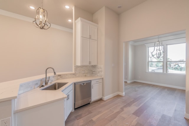 kitchen featuring light wood-type flooring, white cabinets, sink, dishwasher, and hanging light fixtures