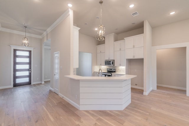 kitchen featuring decorative backsplash, light wood-type flooring, stainless steel appliances, crown molding, and white cabinetry