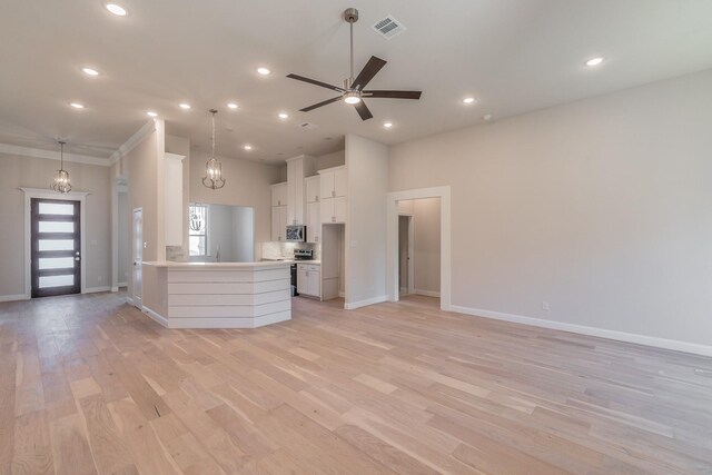 kitchen with white cabinetry, pendant lighting, light hardwood / wood-style floors, and appliances with stainless steel finishes