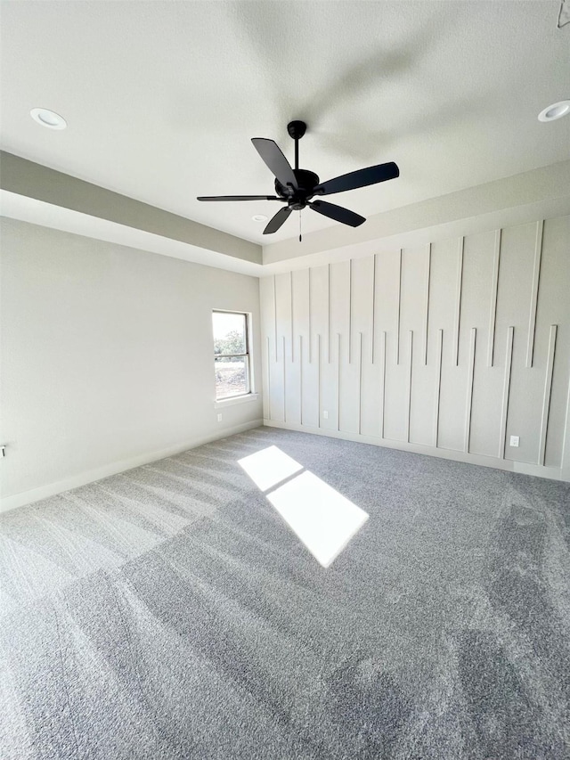 unfurnished bedroom with ceiling fan and carpet