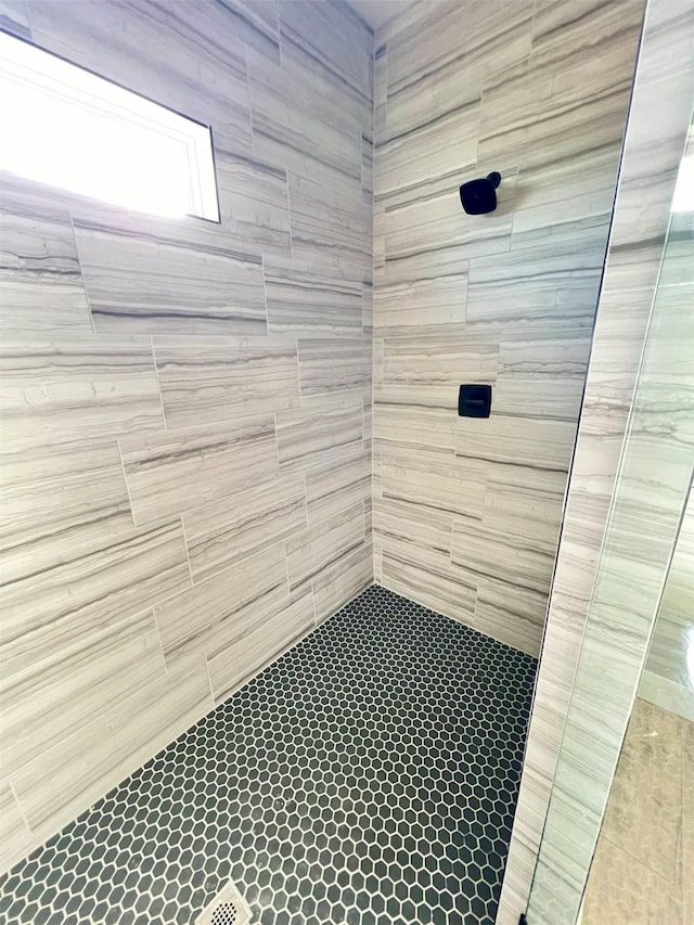 bathroom with a tile shower