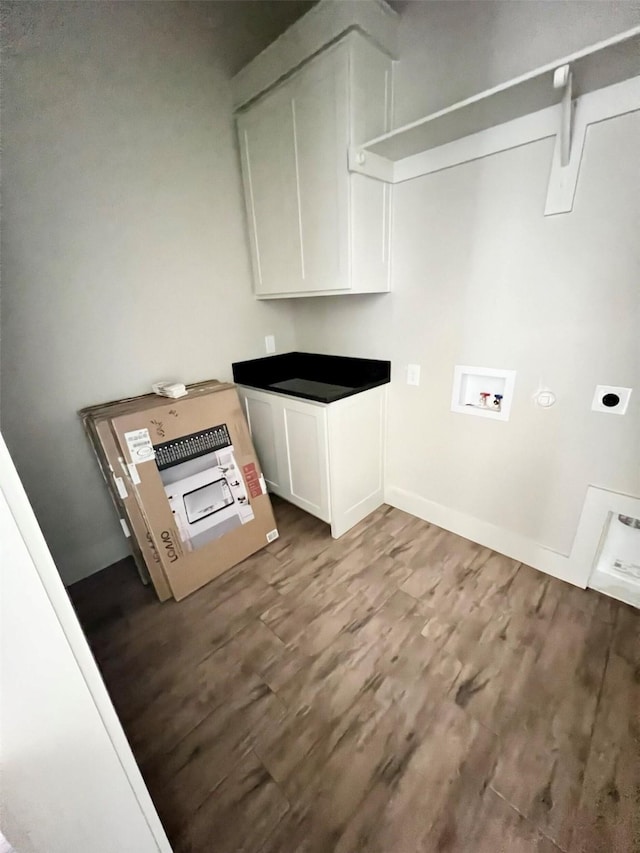 laundry room with cabinets, heating unit, hookup for an electric dryer, washer hookup, and hardwood / wood-style flooring