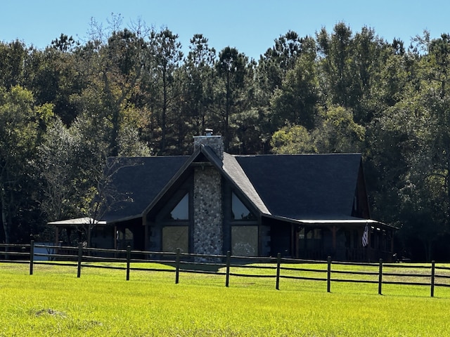 exterior space with a rural view and a lawn