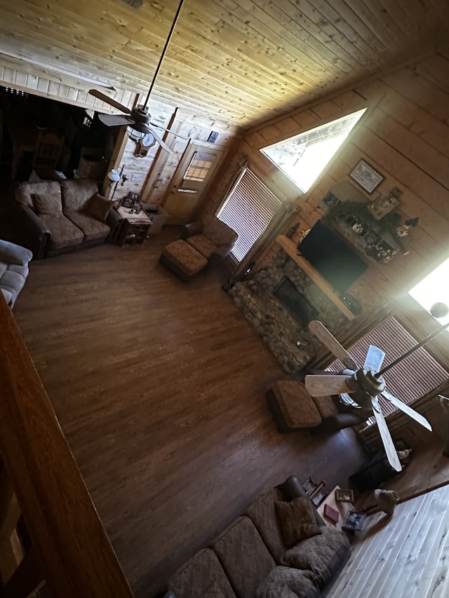 interior space featuring ceiling fan, wooden ceiling, lofted ceiling, wooden walls, and hardwood / wood-style flooring