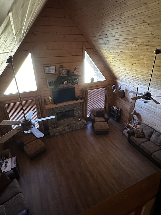 unfurnished living room with wood ceiling, ceiling fan, wooden walls, hardwood / wood-style floors, and lofted ceiling