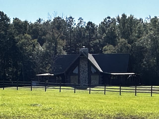 view of home's community with a lawn and a rural view