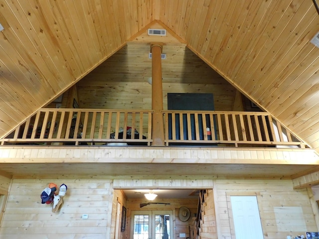 interior details with french doors, wooden walls, and wood ceiling