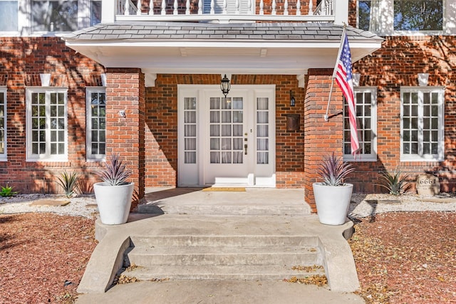 foyer with crown molding and wood-type flooring