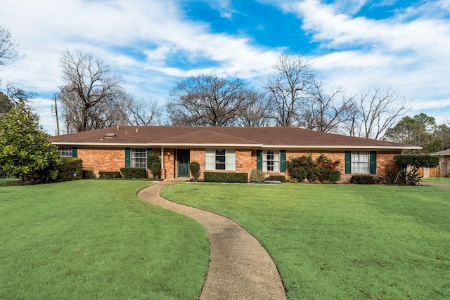 ranch-style home with a front lawn