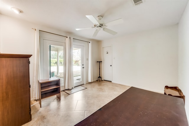 entryway featuring light tile patterned floors and ceiling fan