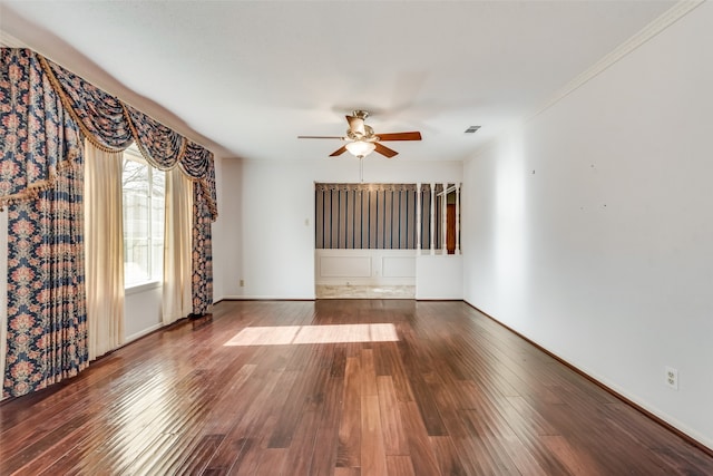 spare room with wood-type flooring, ceiling fan, and crown molding