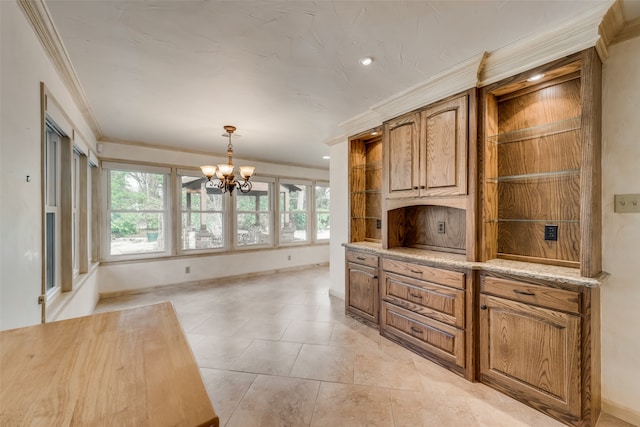 kitchen with light tile patterned floors, an inviting chandelier, hanging light fixtures, and ornamental molding