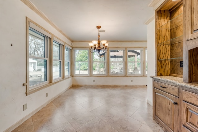 dining room featuring ornamental molding and a notable chandelier