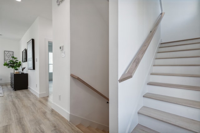 staircase with hardwood / wood-style flooring