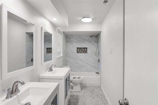 full bathroom with tile patterned floors, toilet, vanity, and tiled shower / bath