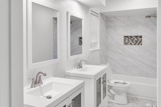 full bathroom featuring tile patterned flooring, vanity, toilet, and tiled shower / bath