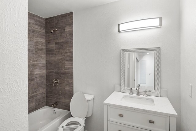 full bathroom with tiled shower / bath combo, toilet, and vanity