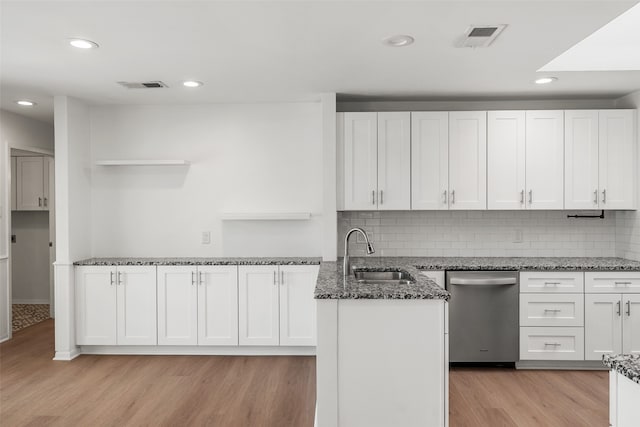 kitchen with light hardwood / wood-style floors, white cabinetry, and sink