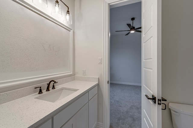 bathroom with toilet, a ceiling fan, and vanity