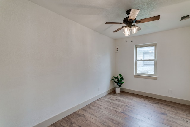 unfurnished room featuring light hardwood / wood-style floors and ceiling fan