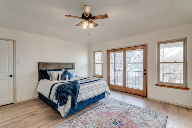 bedroom with ceiling fan, light wood-type flooring, access to outside, and multiple windows