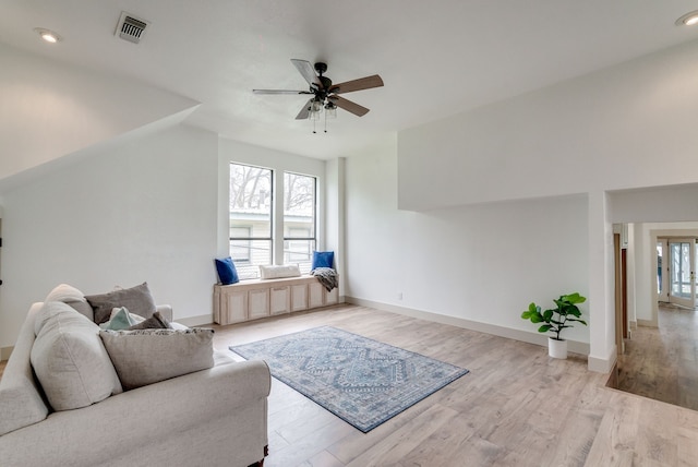 living room featuring ceiling fan and light wood-type flooring