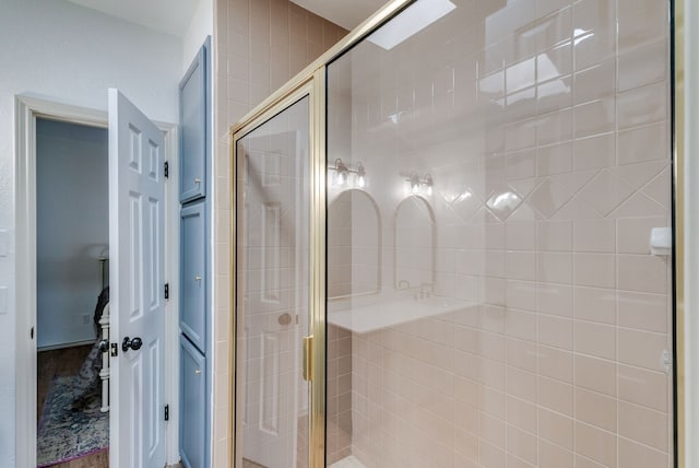 bathroom featuring a shower with door