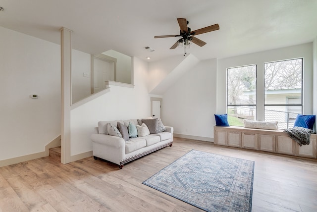 living room featuring light hardwood / wood-style flooring and ceiling fan