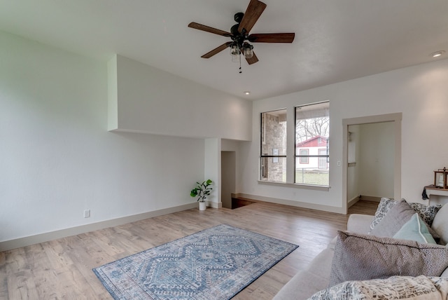 living room featuring ceiling fan and light hardwood / wood-style flooring