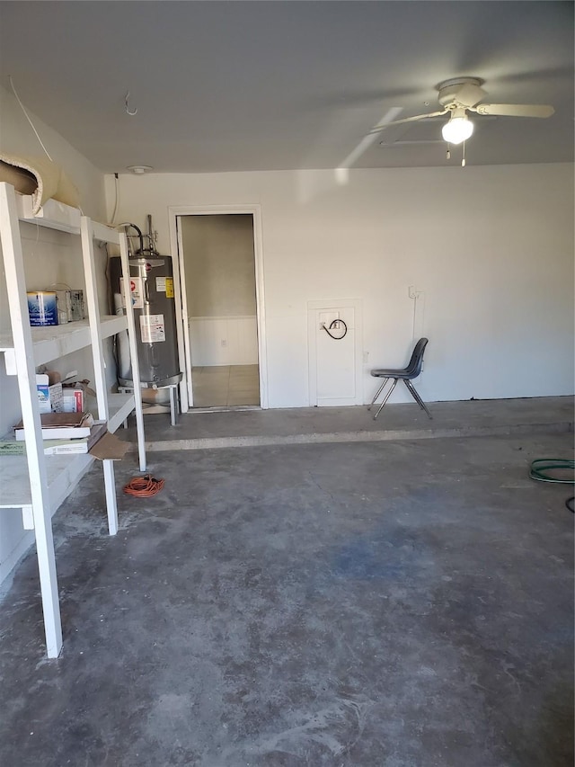 garage featuring ceiling fan and electric water heater