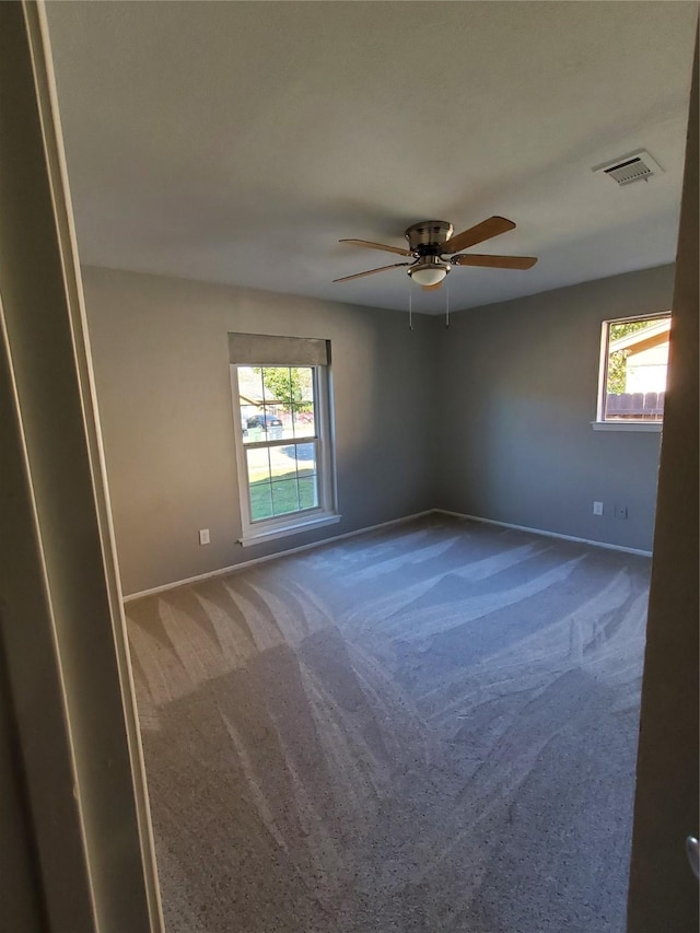 carpeted empty room featuring ceiling fan