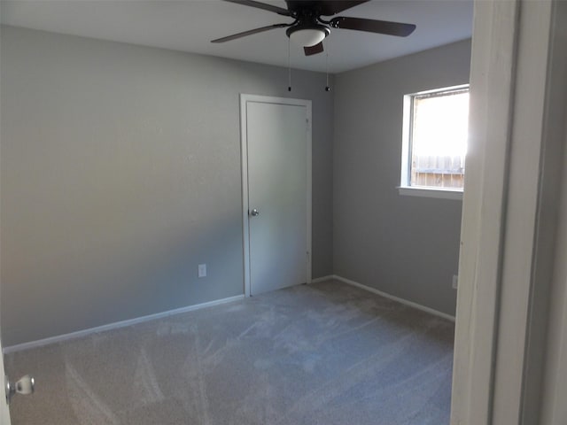 spare room featuring carpet floors and ceiling fan