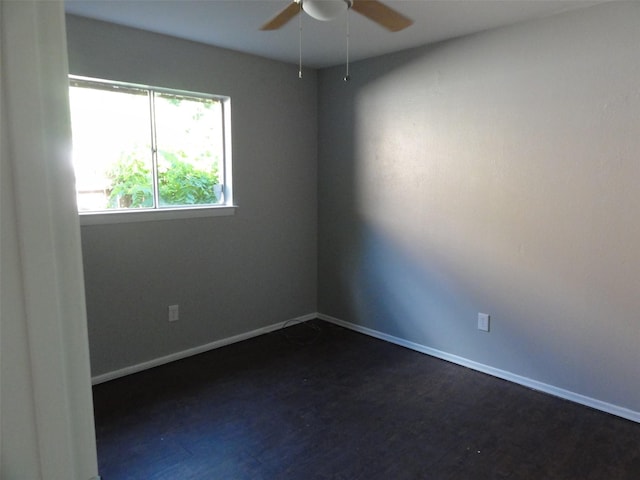 unfurnished room featuring ceiling fan and dark wood-type flooring