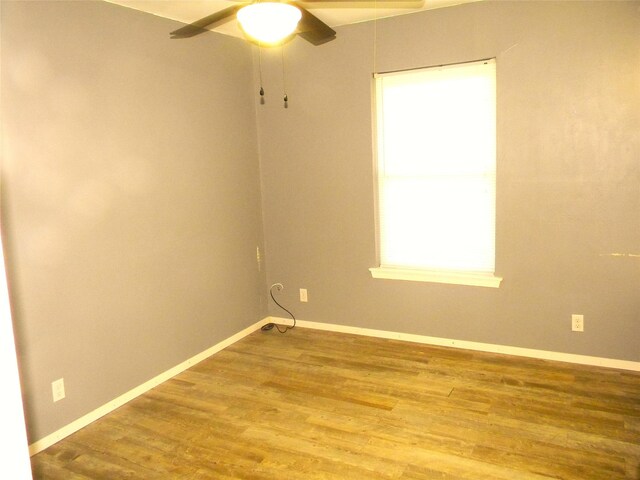 spare room featuring ceiling fan, plenty of natural light, and hardwood / wood-style floors