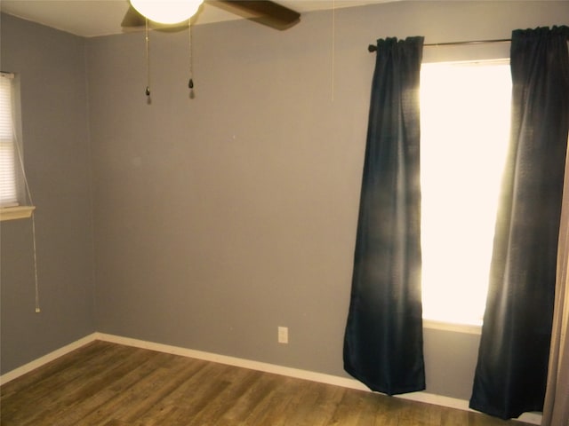 spare room with ceiling fan and dark hardwood / wood-style flooring