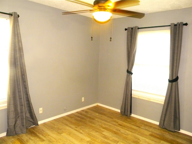 unfurnished room featuring hardwood / wood-style flooring and ceiling fan