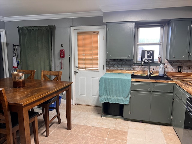 kitchen with butcher block counters, decorative backsplash, sink, and ornamental molding