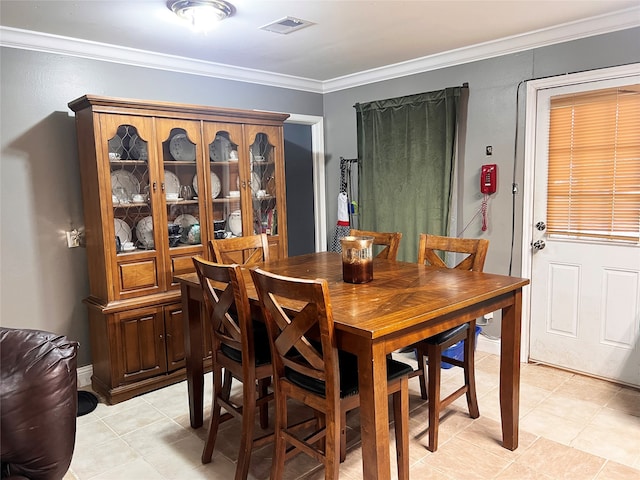 tiled dining area with crown molding