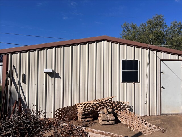 view of outdoor structure featuring a lawn