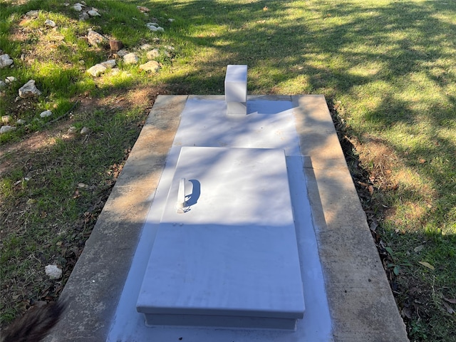 view of storm shelter featuring a lawn