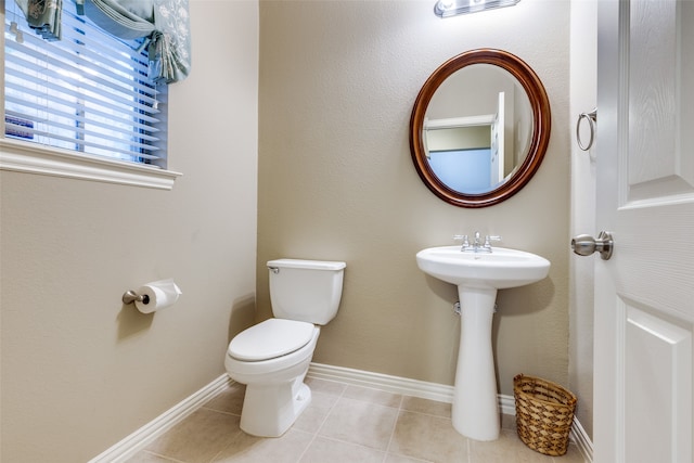 bathroom featuring tile patterned floors, toilet, and sink