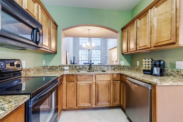 kitchen featuring sink, black appliances, light tile patterned floors, an inviting chandelier, and hanging light fixtures